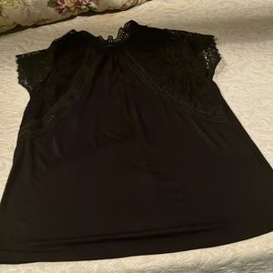 Black blouse size small lacy. Buttons on the back of the neck. Brand new no tags